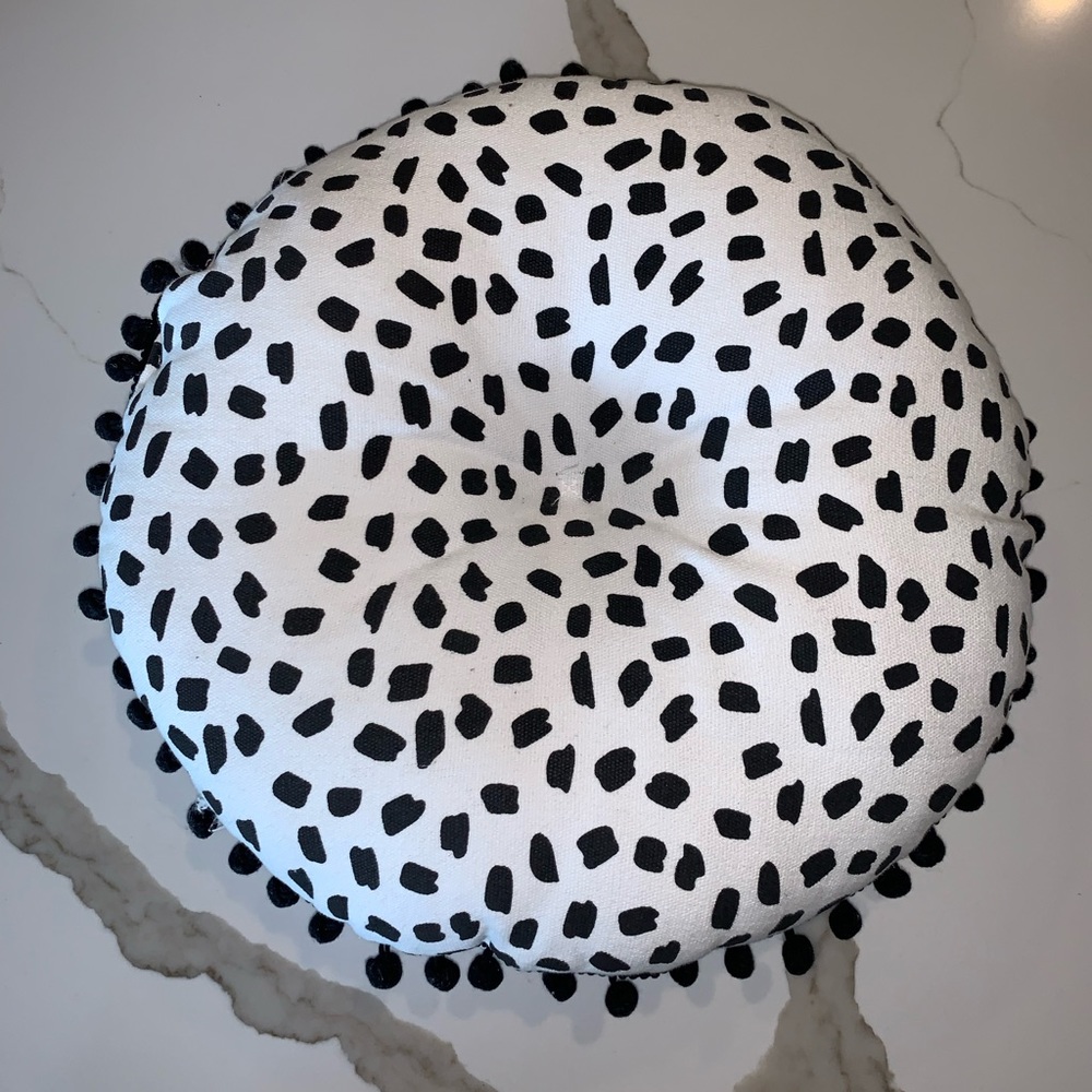 Round Black and White Pillow with Decorative Tassels